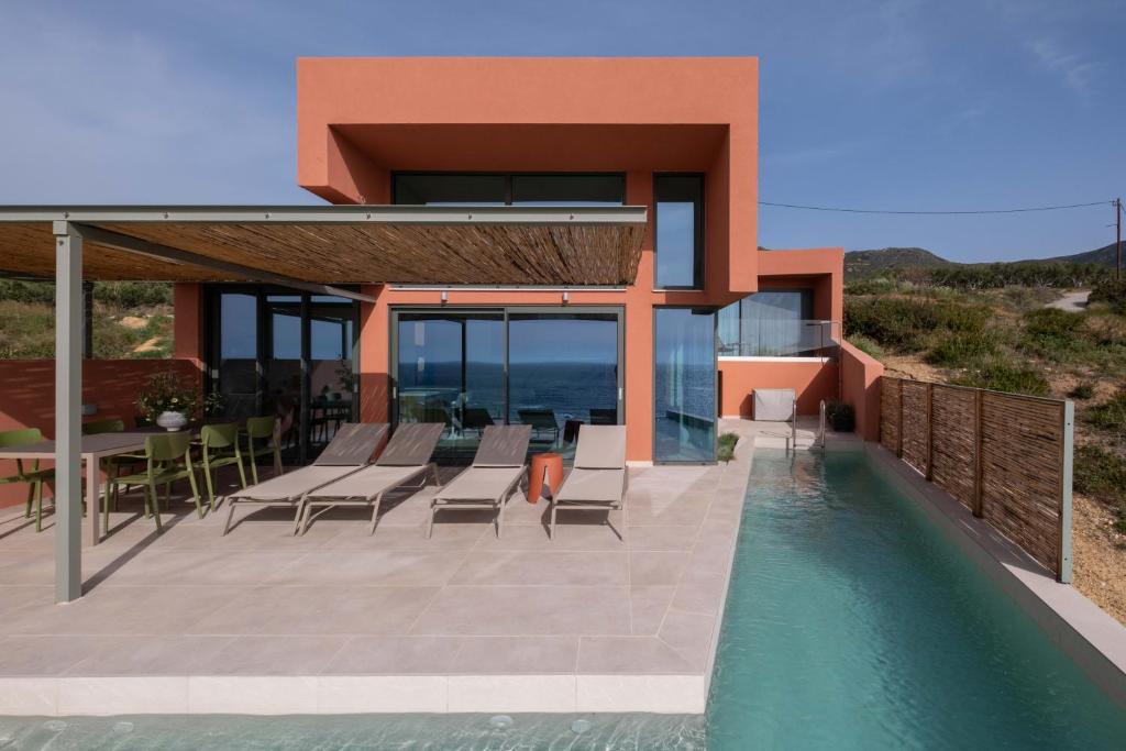 an image of a house with a swimming pool at Casa Tarrha- Beachfront Villa with Heated Pool in Livadia