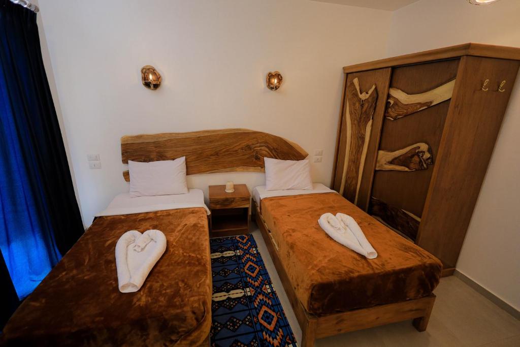 Postel nebo postele na pokoji v ubytování Kaya Nubian House