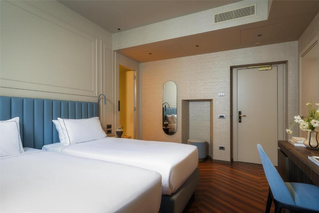 Postel nebo postele na pokoji v ubytování WorldHotel Casati 18