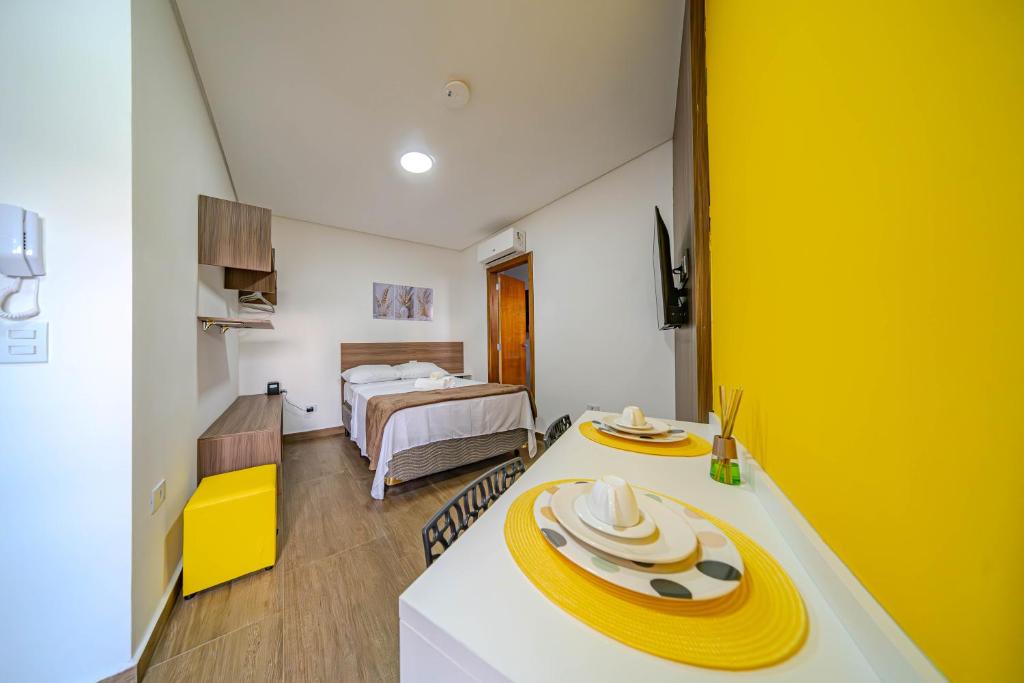 a room with a table with yellow plates on it at Primus House in São Paulo