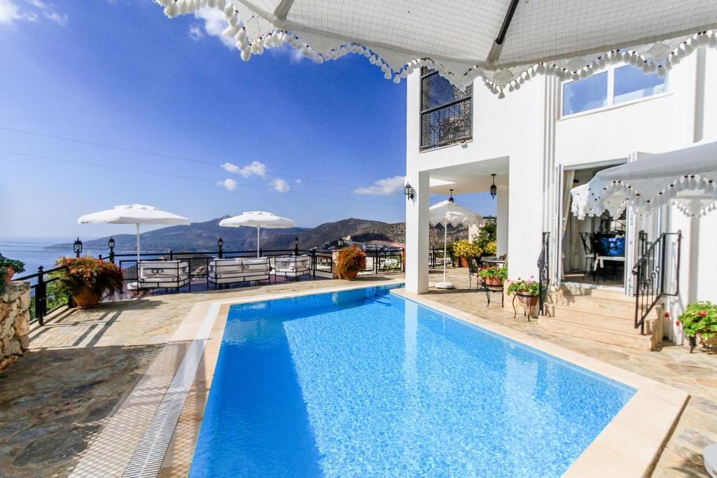 a villa with a swimming pool with a view of the ocean at Villa Dolluca in Kaş
