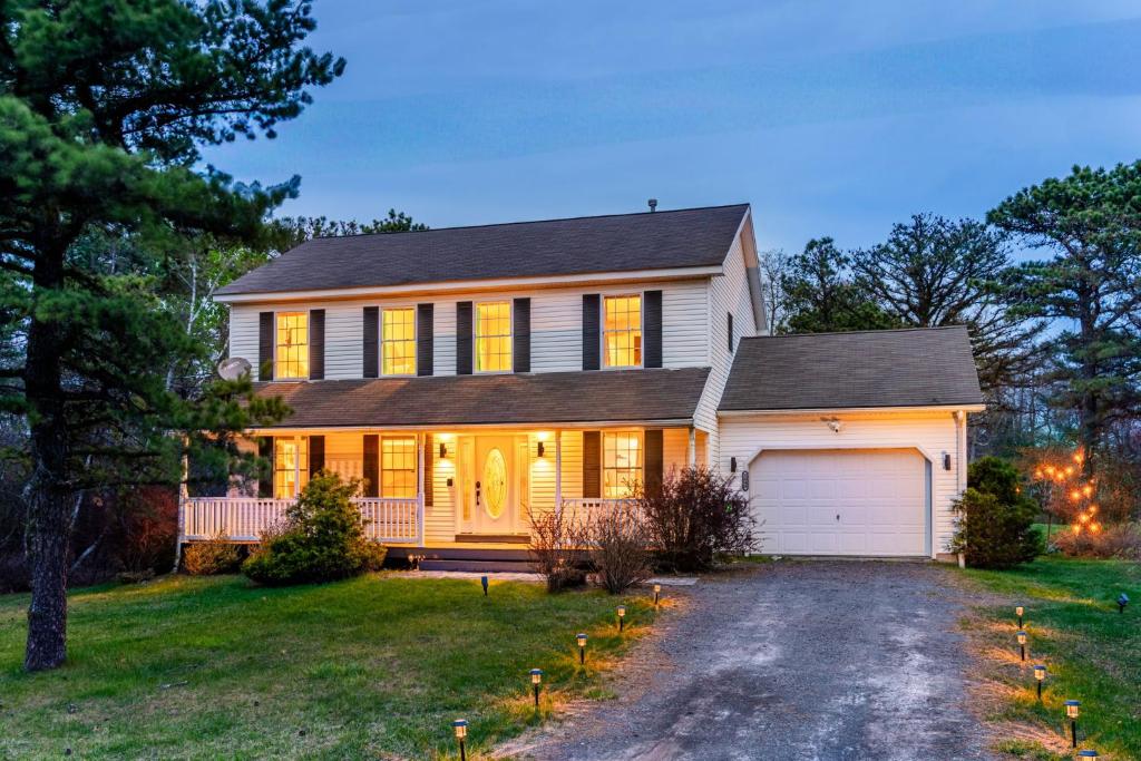 a house with a driveway in front of it at Emerald Lakes Poconos Retreat Game Room, Firepit & Sleeps 10 in Long Pond