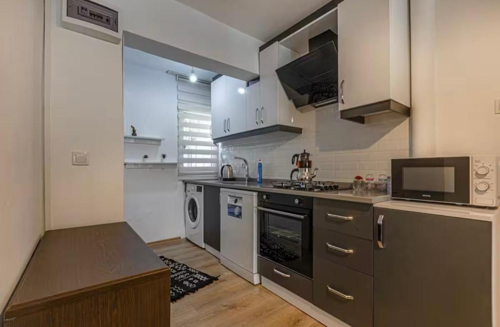 a kitchen with a sink and a stove top oven at Güneş Villa Bahçe Katı in Antalya