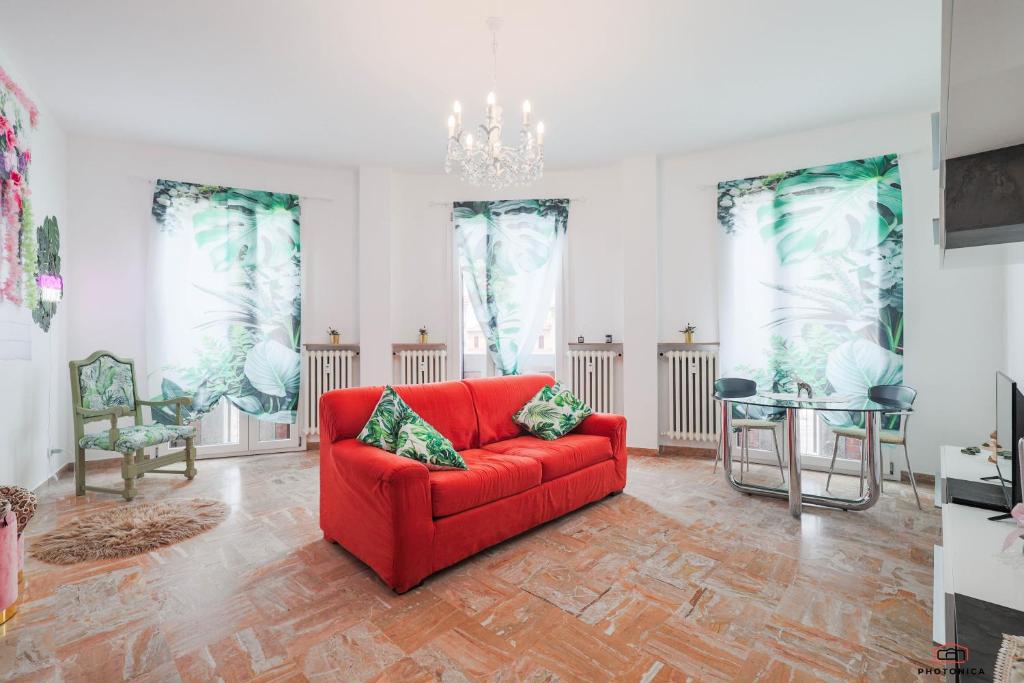 a living room with a red couch and chairs at Angolo prestigioso di Forlì , Wi-Fi , Parcheggio in Forlì