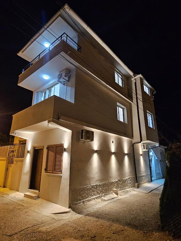 a building with a light on the side of it at night at Guest House Deon in Vlorë