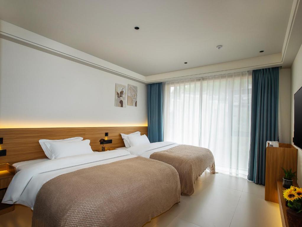 Postel nebo postele na pokoji v ubytování Fenghuang County Jiduo Intelligent Hotel