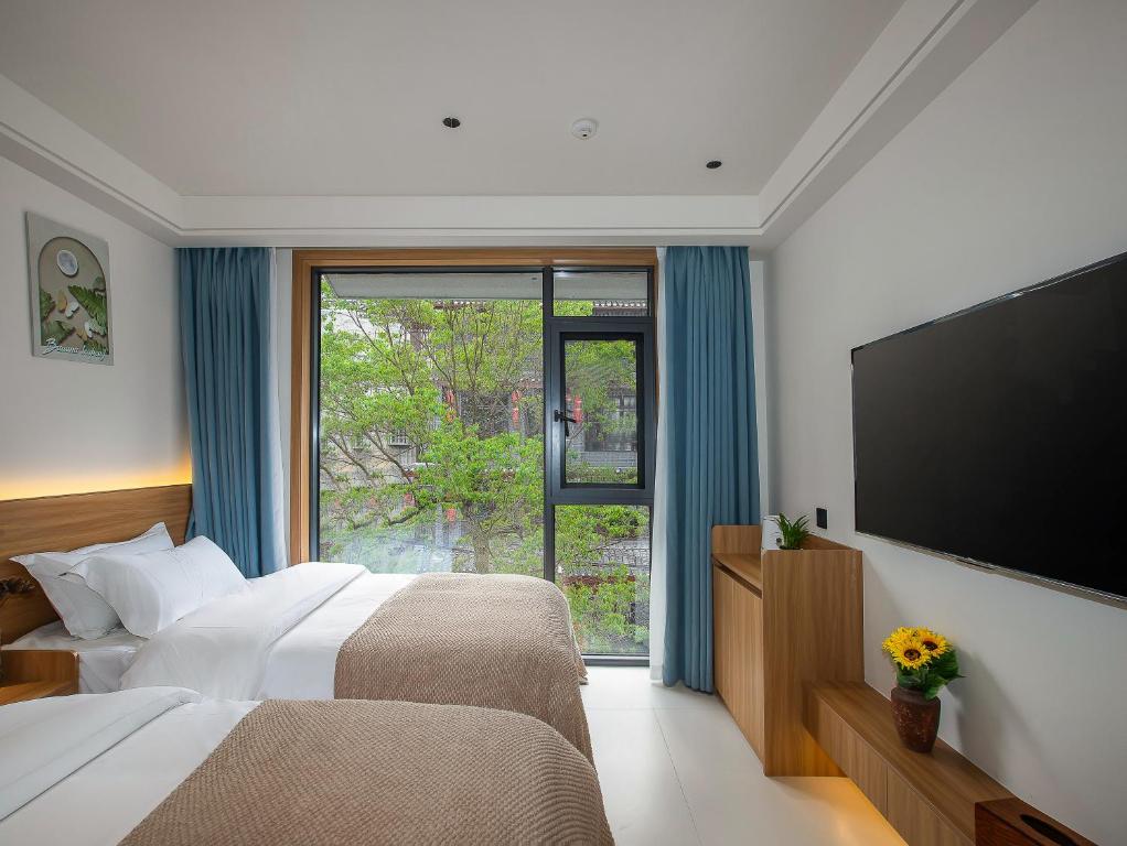 Postel nebo postele na pokoji v ubytování Fenghuang County Jiduo Intelligent Hotel