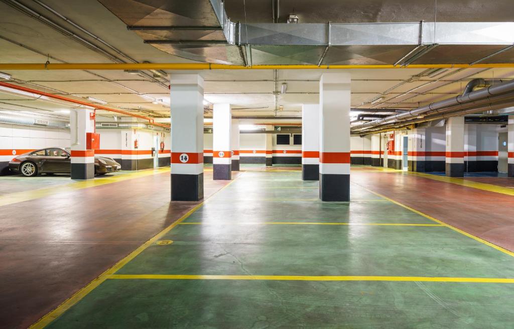 an empty parking garage with a car parked in it at Catalonia Málaga in Málaga
