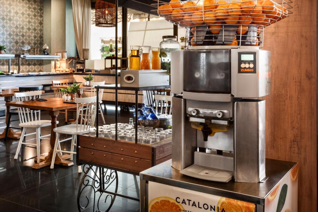 a coffee machine on a stand in a restaurant at Catalonia Málaga in Málaga