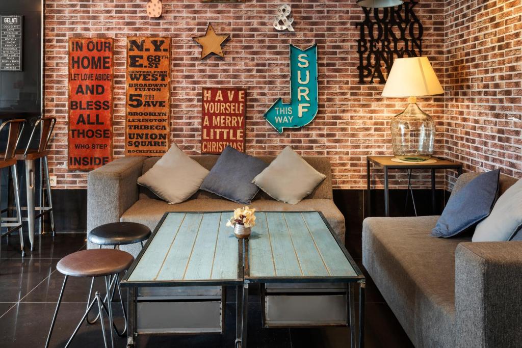 a living room with a couch and a table at Catalonia Málaga in Málaga