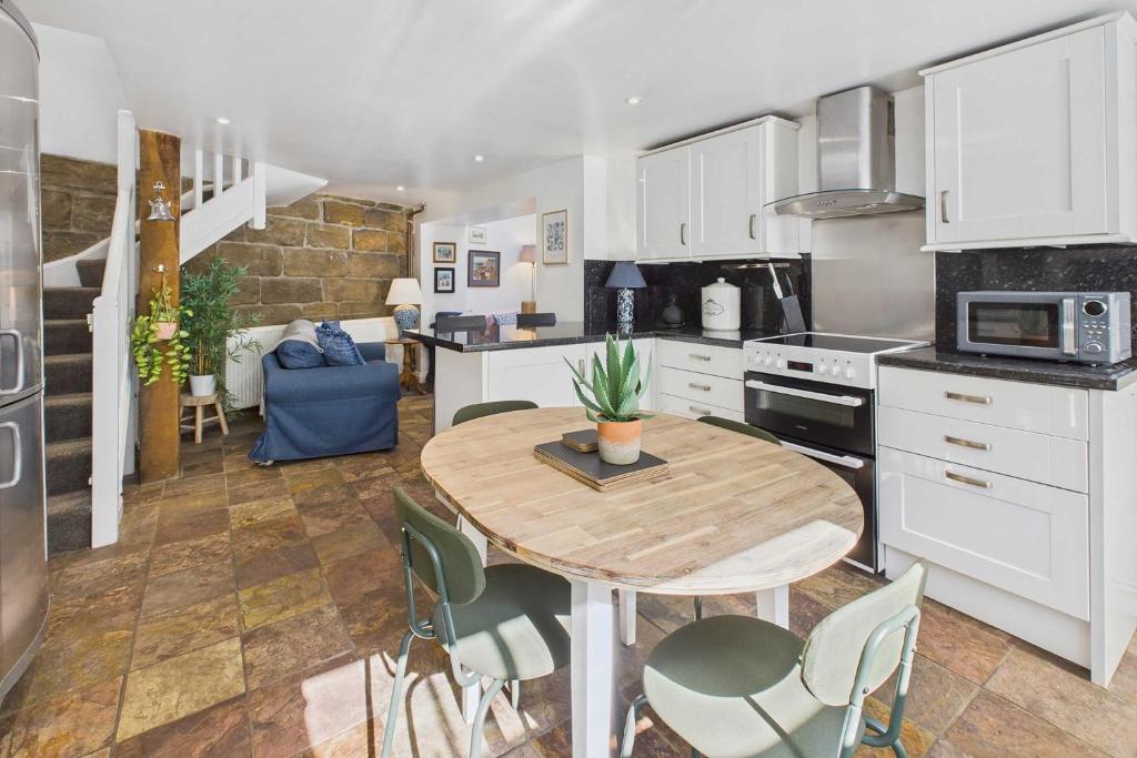 a kitchen with a table and chairs in a kitchen at Host & Stay - Luna Cottage in Staithes