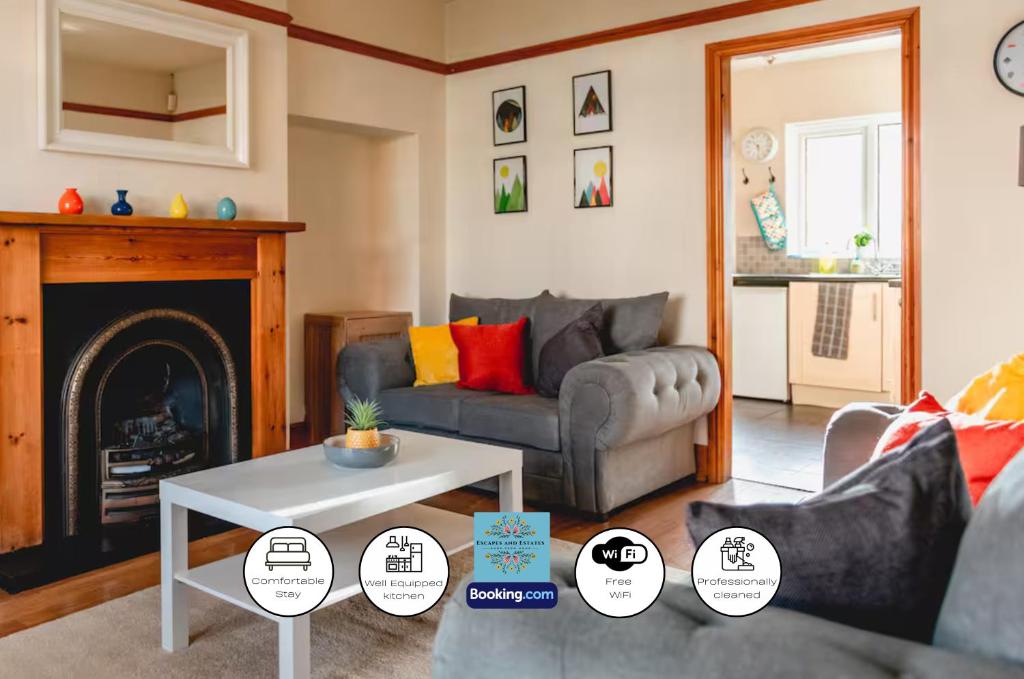a living room with a couch and a fireplace at 3 Bedroom House By Escape & Estates Short Lets & Serviced Accommodation Birmingham With Patio & Garden in Birmingham