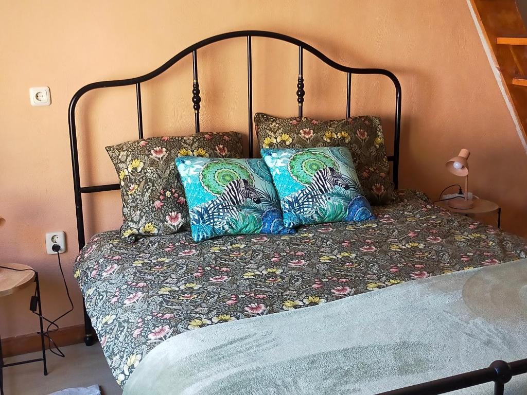 a bed with two pillows on top of it at BnB Het Geluk van Limburg in Mechelen