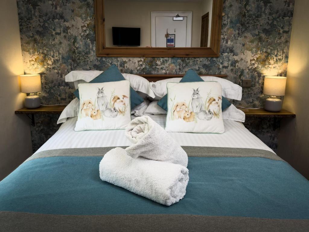 Postel nebo postele na pokoji v ubytování Borgie Lodge Hotel