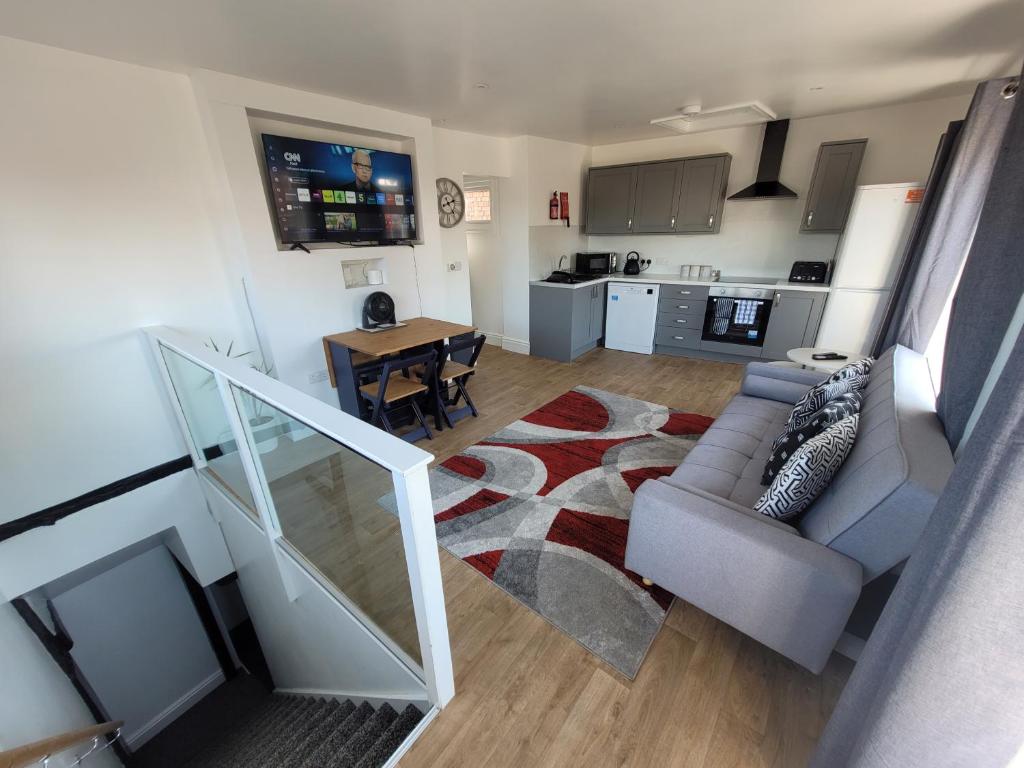 a living room with a couch and a table at City Centre Wallgate Apartments- Step back into Roman history in Colchester