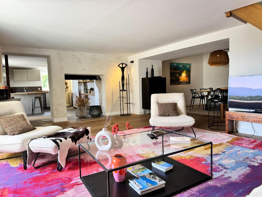 a living room with a glass coffee table at Duplex de la Glacière Maison Châteaux & Lavandes in Grignan