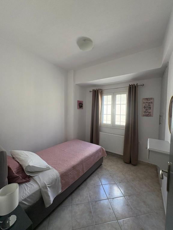 Postel nebo postele na pokoji v ubytování ATHOS APARTMENT
