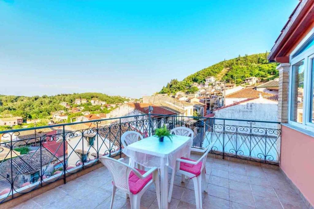a balcony with a table and chairs and a view at Contessina Stamy Panoramic 360 in Ágios Matthaíos