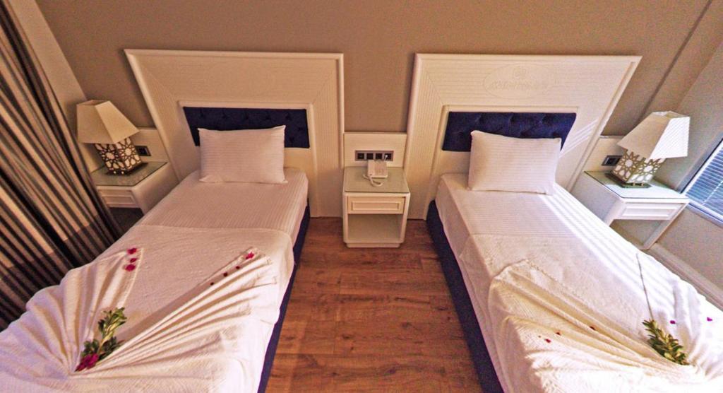 Postel nebo postele na pokoji v ubytování Mara Palas Hotel