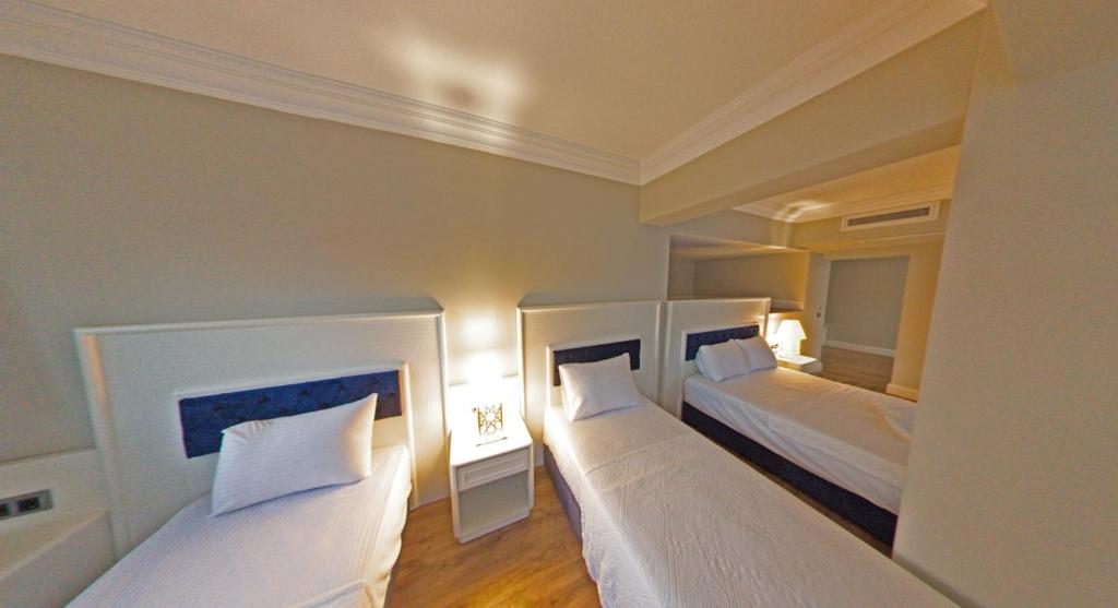 Postel nebo postele na pokoji v ubytování Mara Palas Hotel