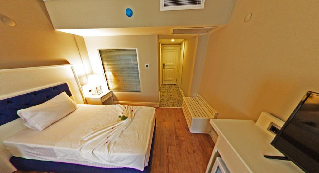 Postel nebo postele na pokoji v ubytování Mara Palas Hotel