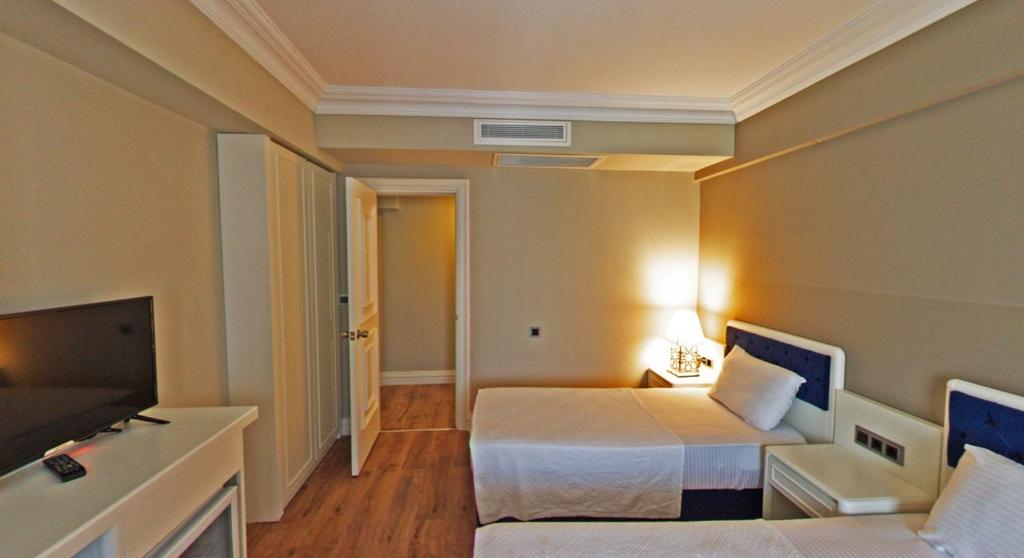 Postel nebo postele na pokoji v ubytování Mara Palas Hotel