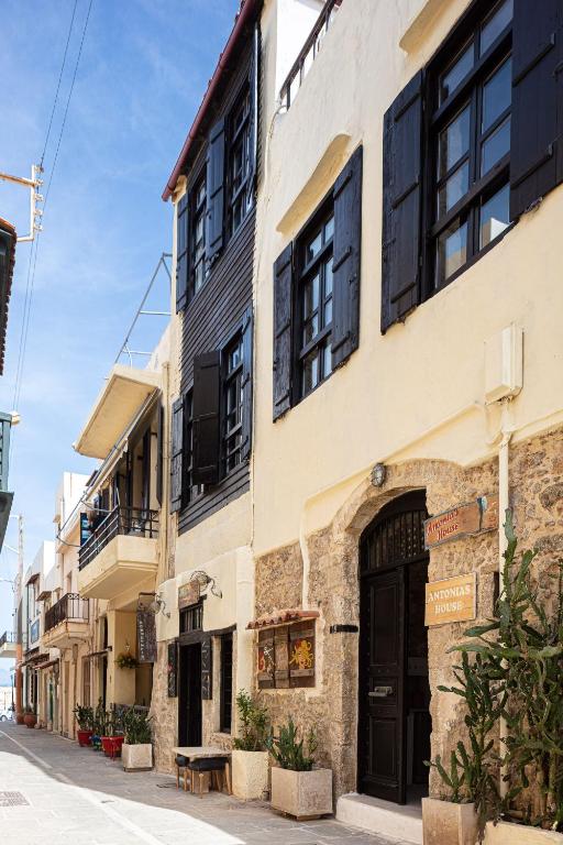 a building with black doors and windows on a street at Antonia's House - Old town in Rethymno