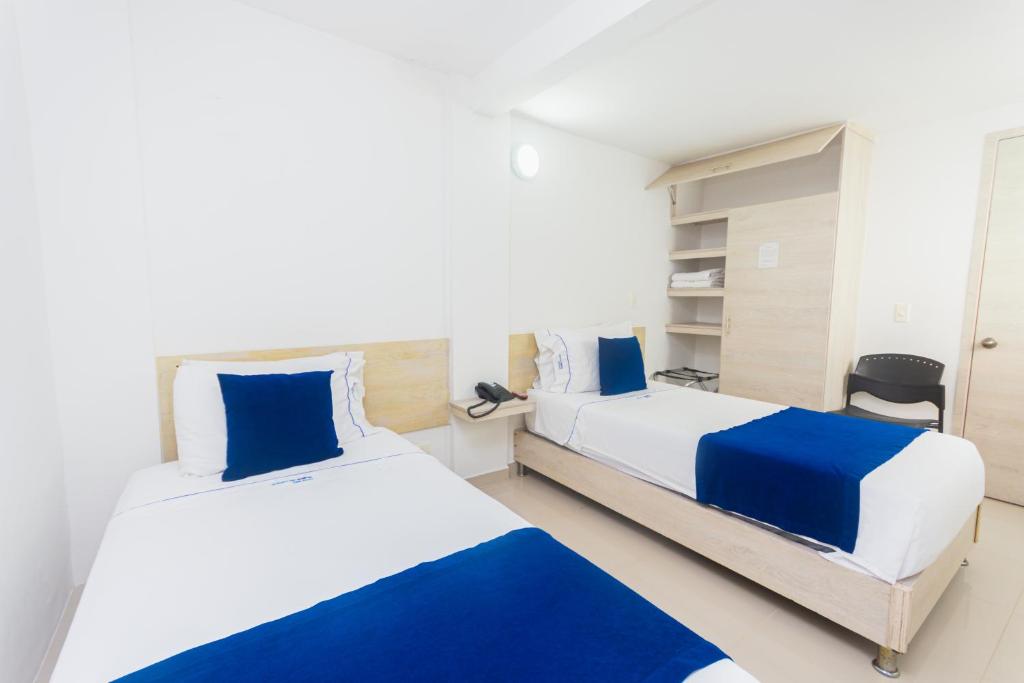 Postel nebo postele na pokoji v ubytování Hotel Suite del Parque