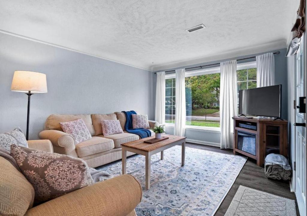 a living room with a couch and a tv at Modern 3Bed Home Near CLE With Private Backyard in Parma Heights