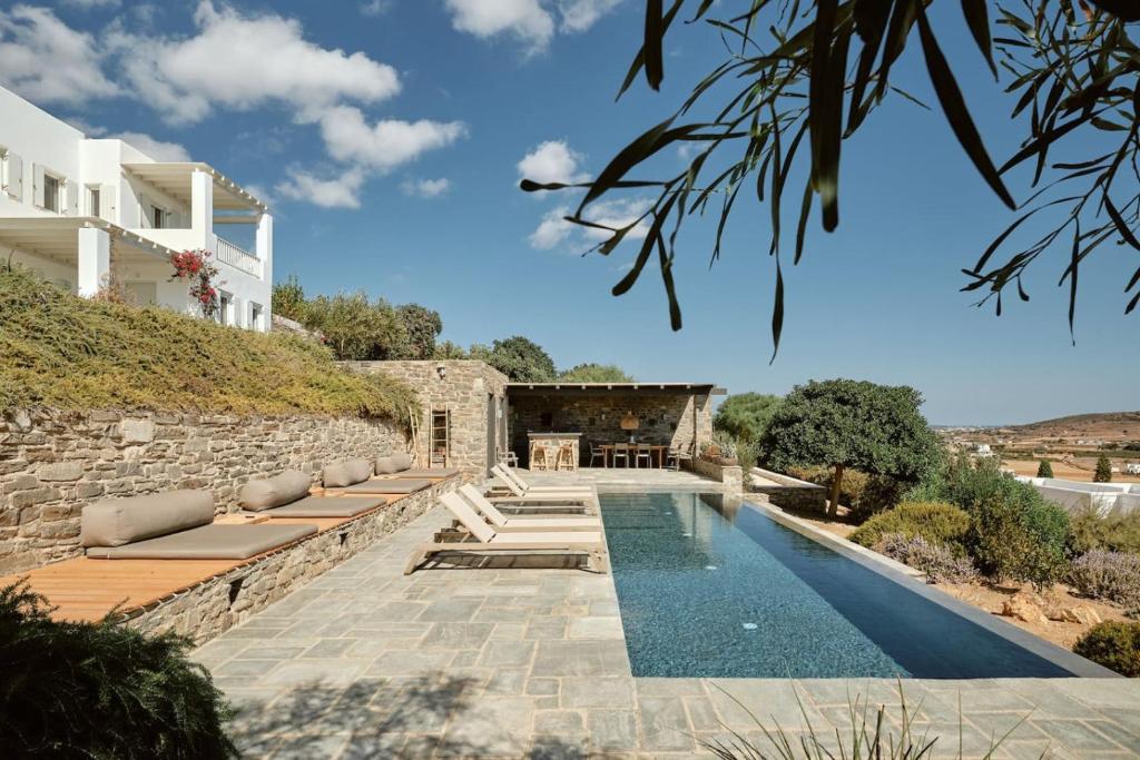 a villa with a swimming pool and a house at Villa Inke - Secluded Luxury in Kóstos