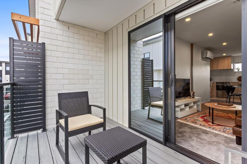 a balcony with a chair and a table at Perfect For You and Your Family in Auckland