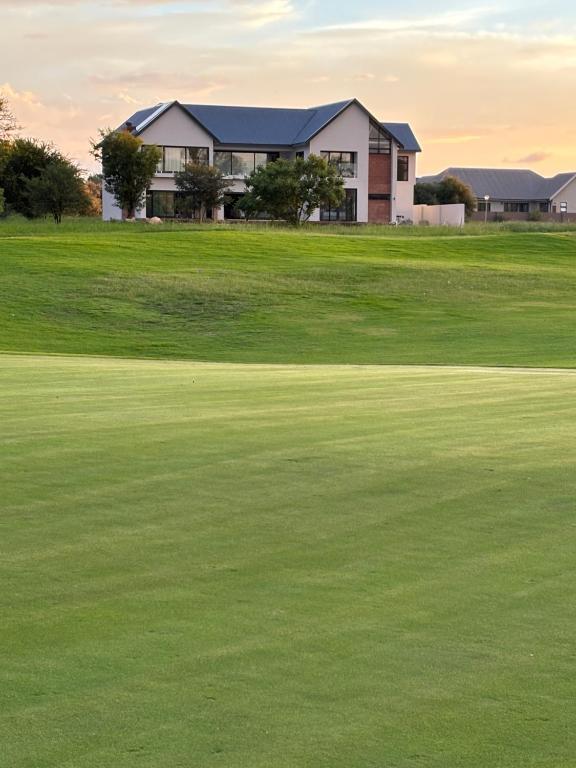 a house on a golf course with a green at Villa 374 Vaal De Grace in Grooteiland