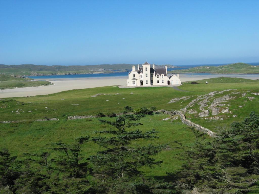 an island with a castle on top of a green field at Uig Lodge in Uig