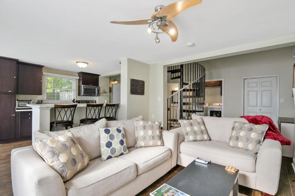 a living room with a white couch and a kitchen at Haymount Hideaway in Fayetteville
