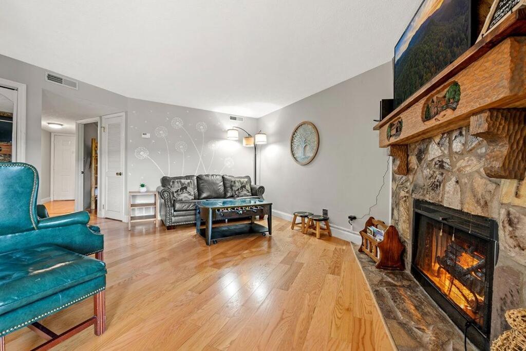 a living room with a couch and a fireplace at Windy Oaks Condo by Avada Properties in Gatlinburg