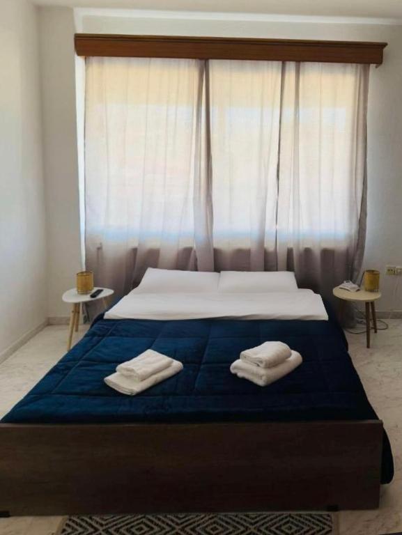 a bedroom with a bed with two towels on it at Cozy apartment comfy 1 in Serres