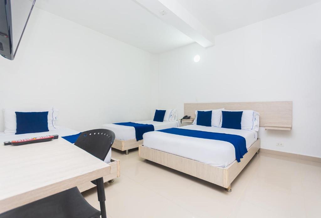 Postel nebo postele na pokoji v ubytování Hotel Suite del Parque