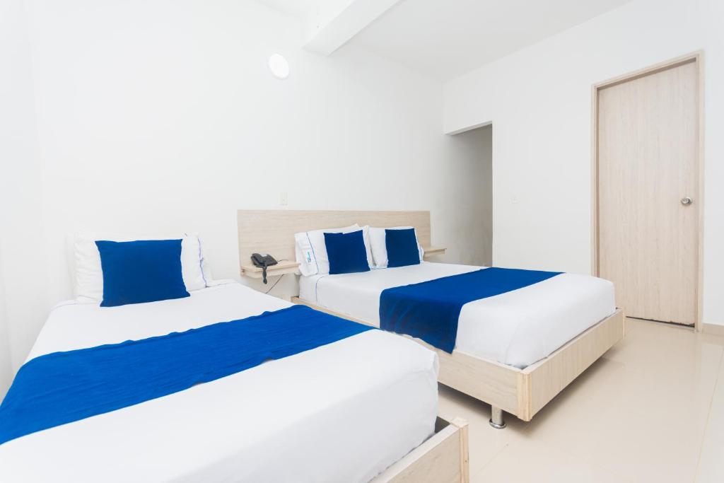 Postel nebo postele na pokoji v ubytování Hotel Suite del Parque