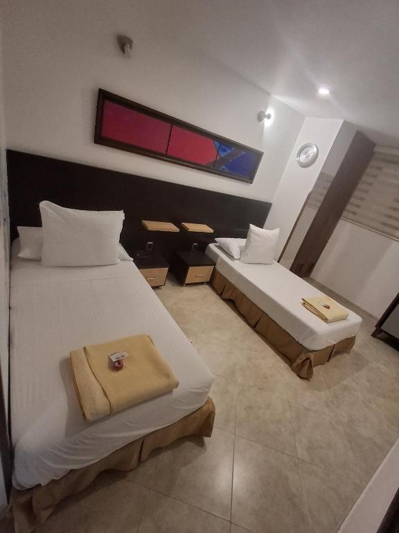 Postel nebo postele na pokoji v ubytování Hotel Alessio