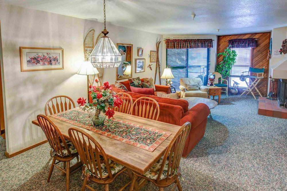 una sala de estar con una mesa y un sofá en Aspen Creek #119 Shared Pool Hot Tub & BBQ, en Mammoth Lakes