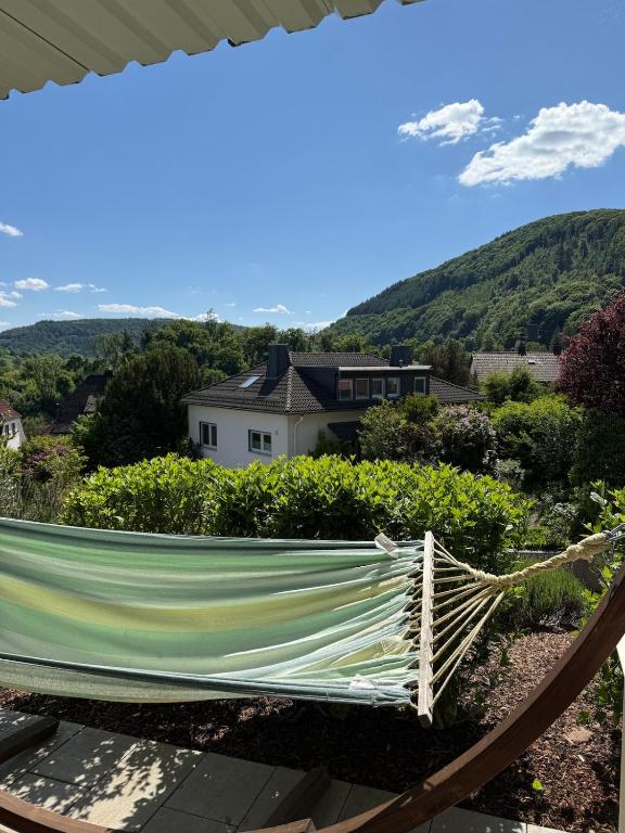 a hammock on a patio with a view of a house at Three-castle-view in a new appartment in Neckarsteinach