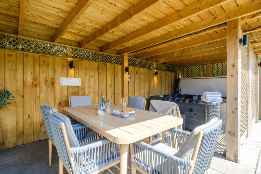 a wooden table and chairs on a patio at The Bank House in Silverdale
