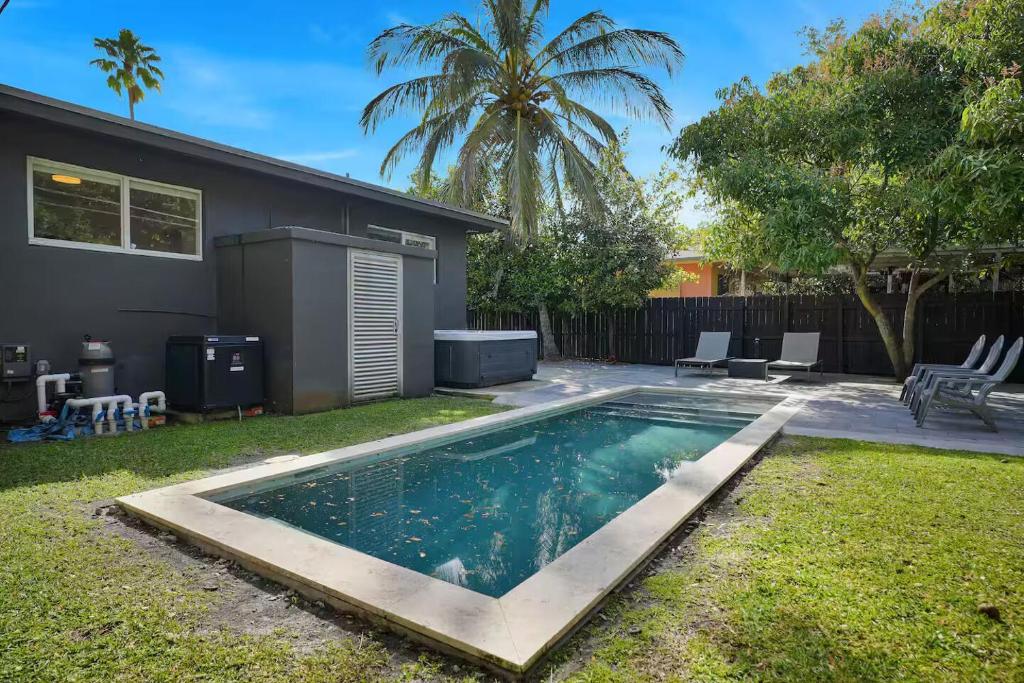 a swimming pool in the yard of a house at 175 Casa Buena Blanca in Miami