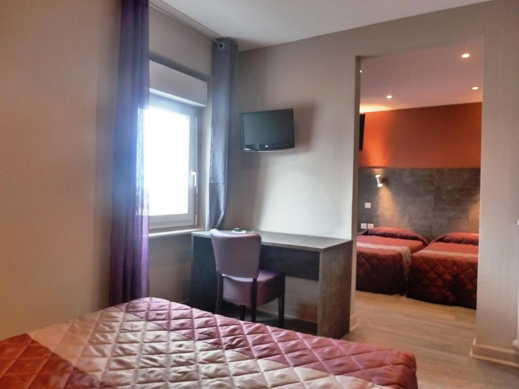 Postel nebo postele na pokoji v ubytování Hôtel Concorde - Rodez Centre Ville