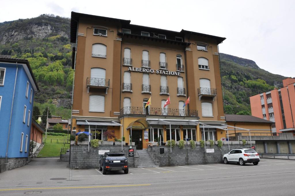 a hotel with cars parked in front of it at Albergo Stazione in Bodio