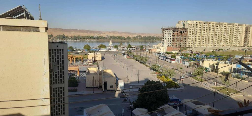 a view of a city with a river and buildings at Downtown Apartment in Aswan