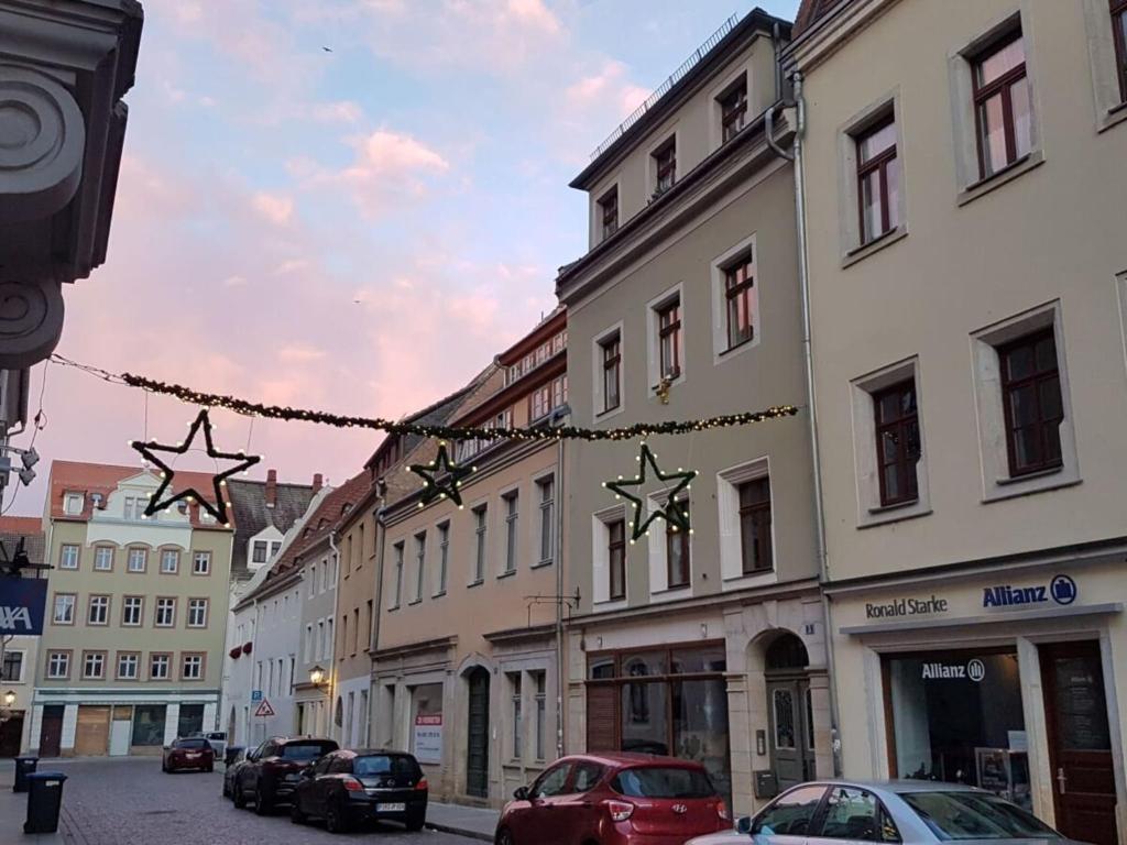 a city street with stars hanging from buildings at above painters studio in Pirna