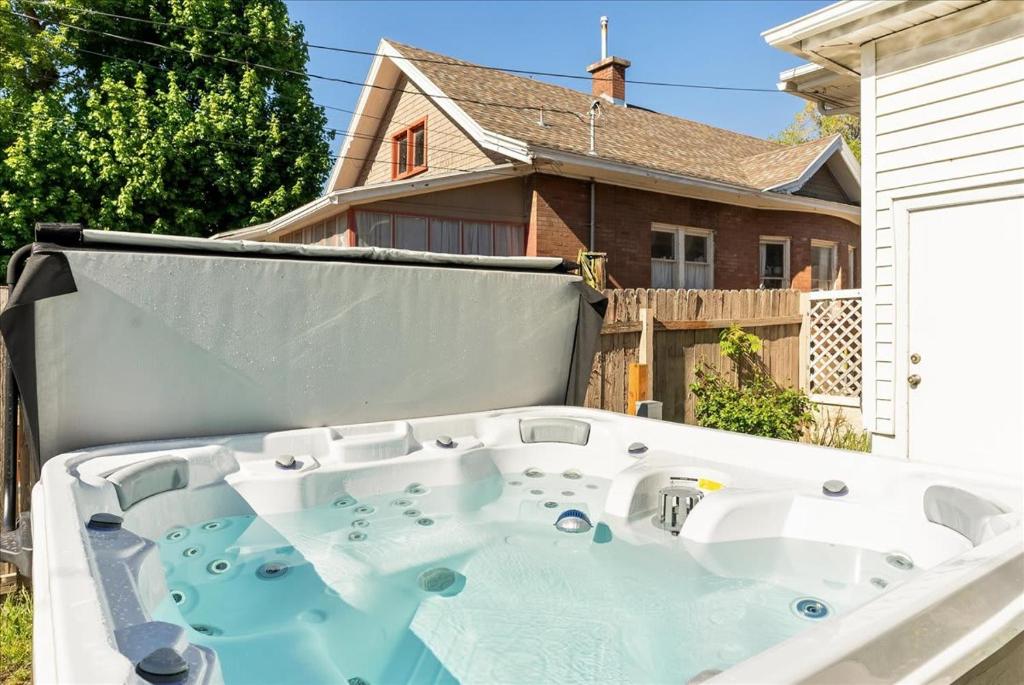 a large bath tub on the back of a house at Private HotTub GameRoom and Fenced Backyard in Ogden