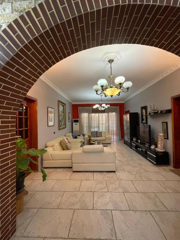a living room with a couch and a table at Casa Shpresë - The Traditional Suite in Tirana