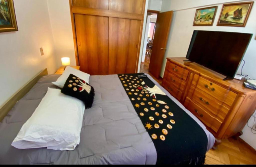 a bedroom with a bed with two pillows on it at Lindo Departamento Centro in Osorno